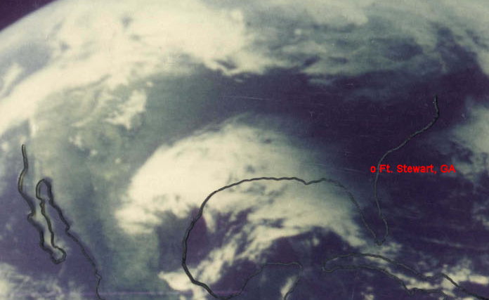 Satellite image of the Moon's shadow as it travels up the east coast of the United States darkening the cloud bank that was also moving northward.